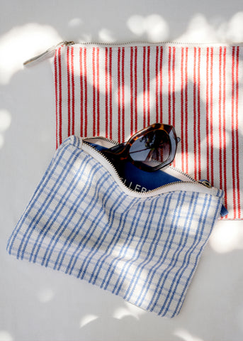 Stilleben Pouches in Checked Blue and Structure Red with sunglasses