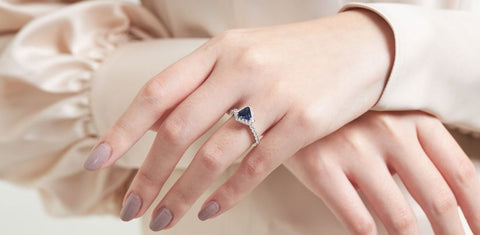 Diana ring with lab grown triangle calf blue sapphire and diamond gem stones.