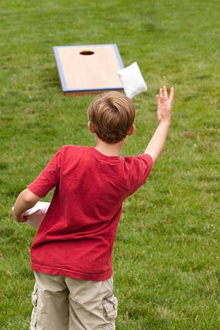 tossing a cornhole bag