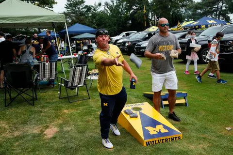 playing cornhole at the tailgate party