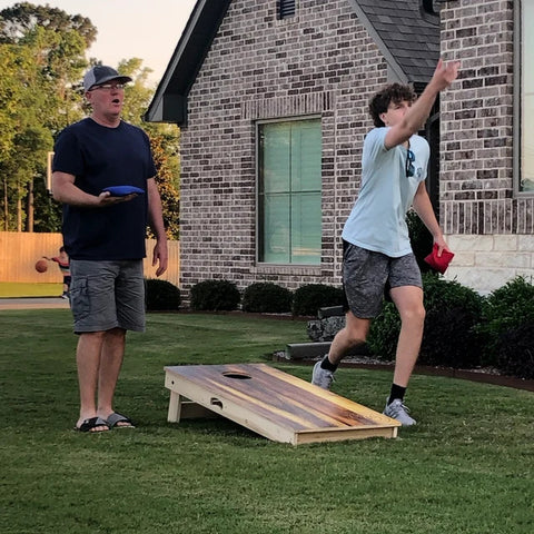 kids playing cornhole