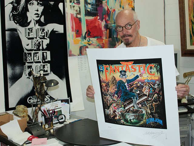 Alan Aldridge with his print of Elton John's Captain Fantastic album cover
