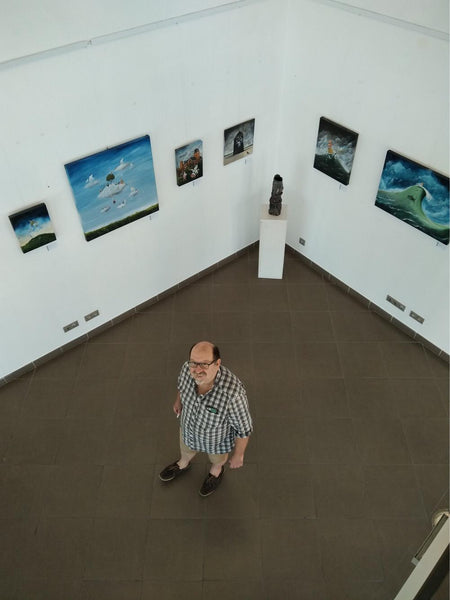 Portrait of Jon Everitt in an exhibition of his paintings