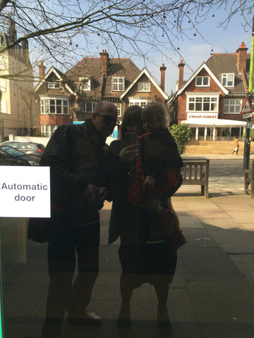 Rob, Emily and daughter Gwen reflected in the StormStudios door