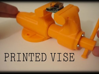 A 3D-printed vise with an extruding tightening arm on the right side.