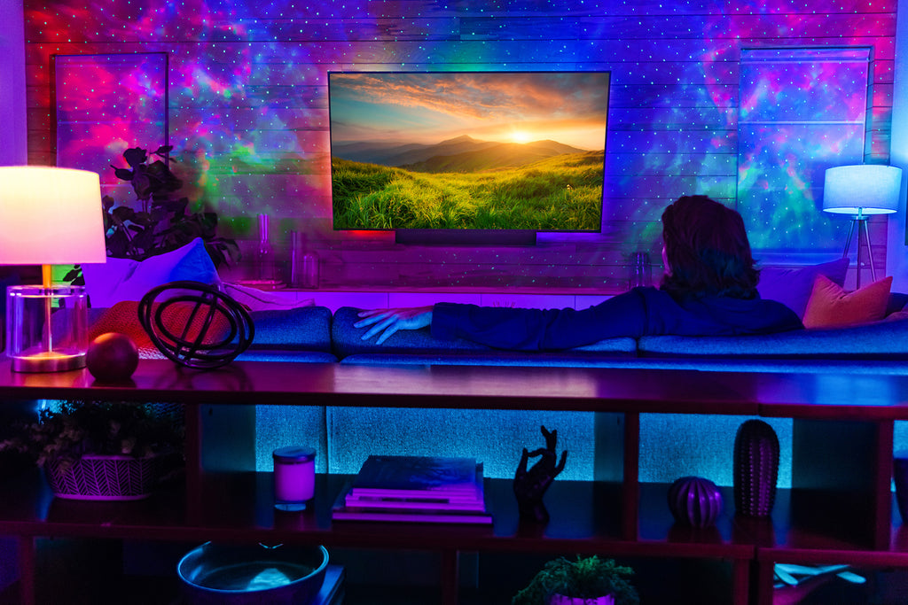 man watching tv with led strip lights and galaxy lighting
