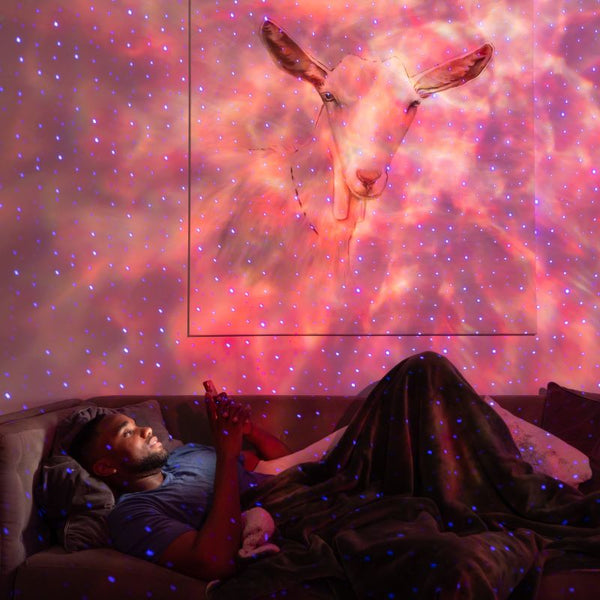 young man relaxing under galaxy lighting