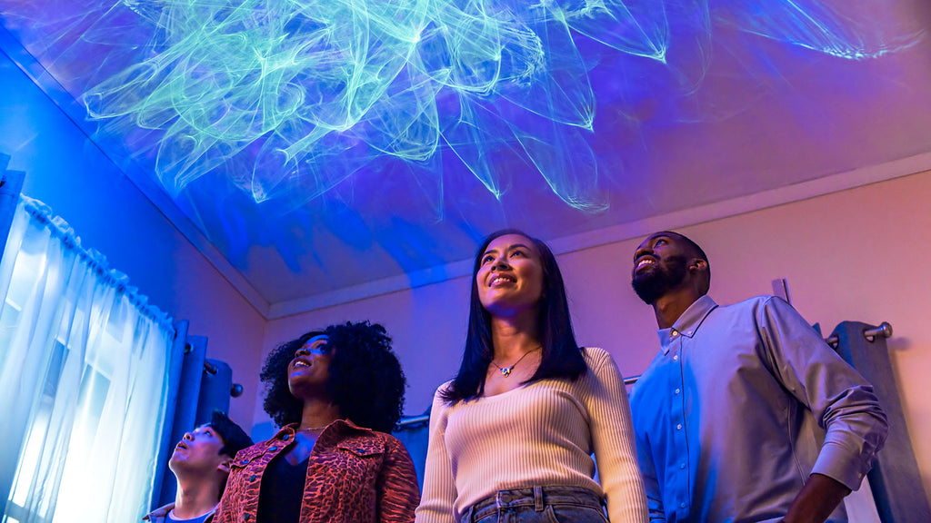 smiling people looking at ark aurora light on ceiling