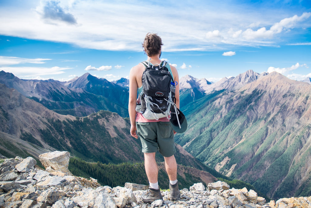 man wearing backpack on a scenic hike