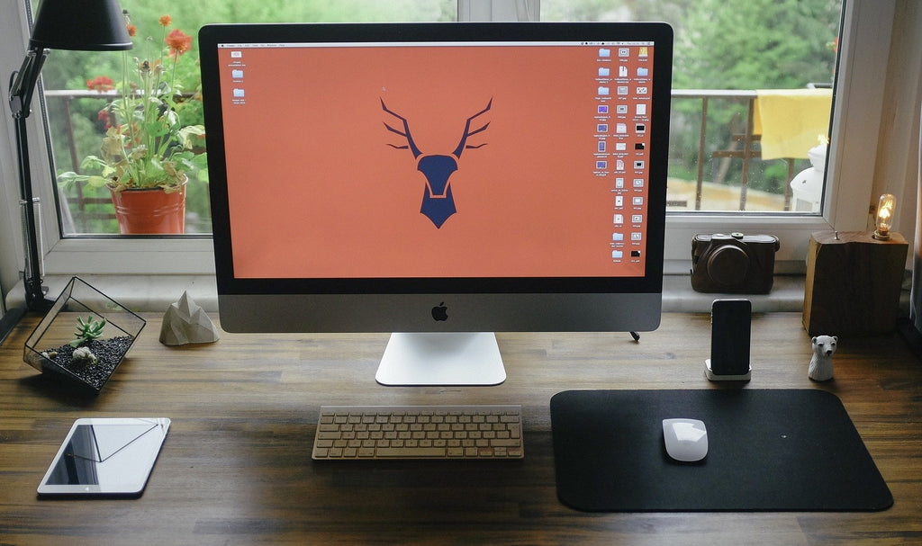 home office iMac with natural light and desk lamps