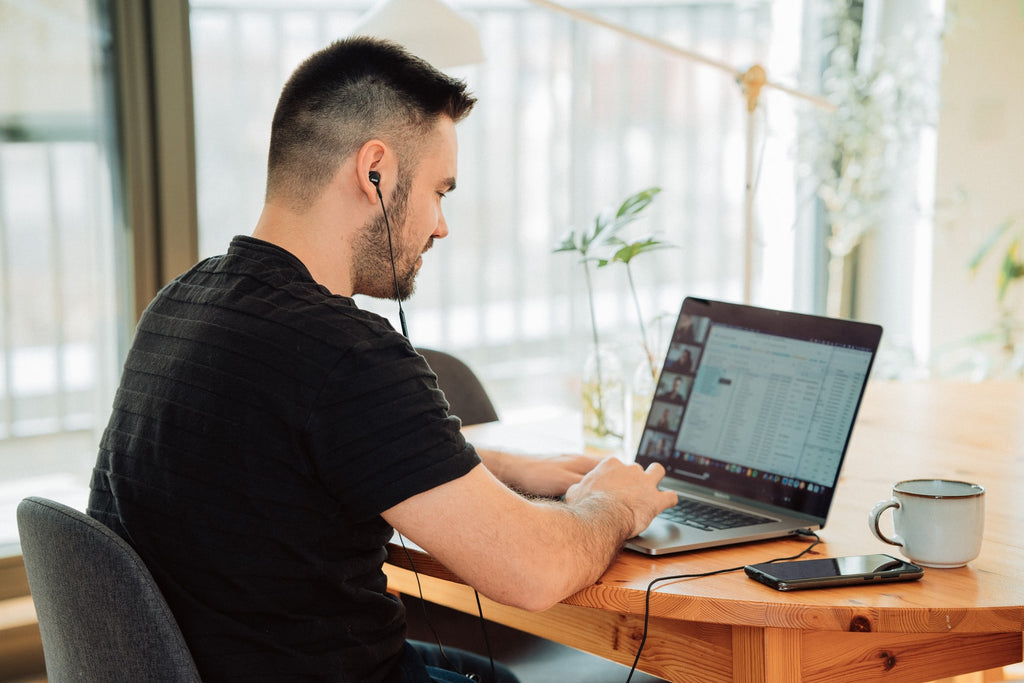 man sitting next to window during zoom call