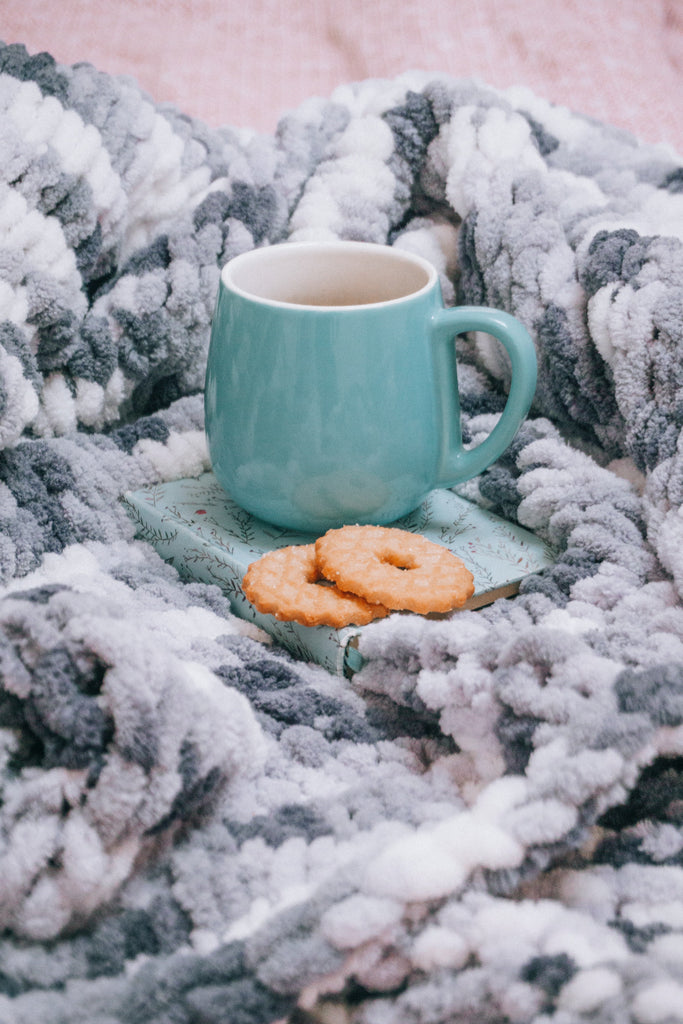 cozy blanket with book and snacks