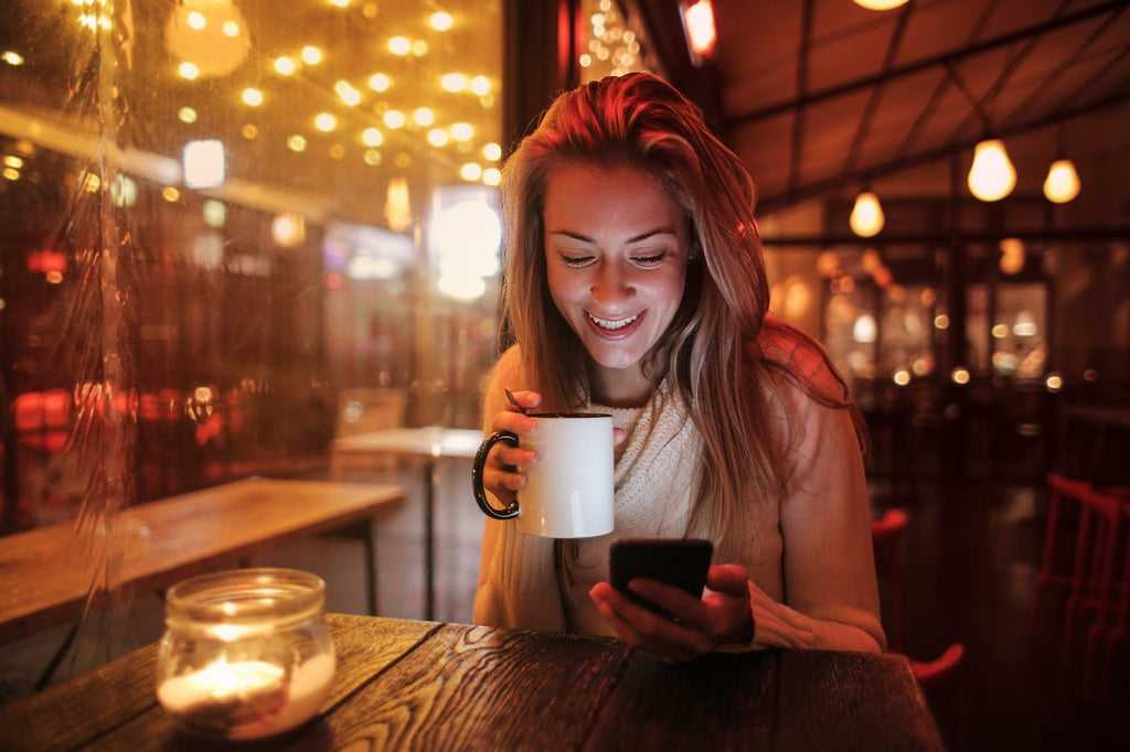 woman drinking coffee in warm lighting
