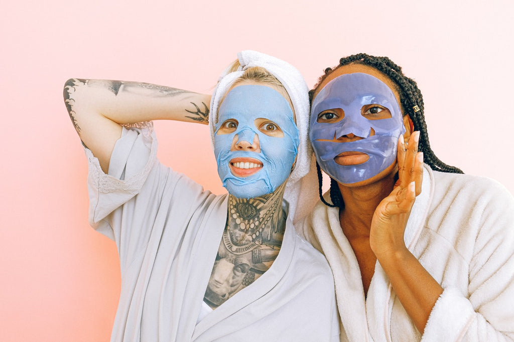 two smiling women with spa face masks