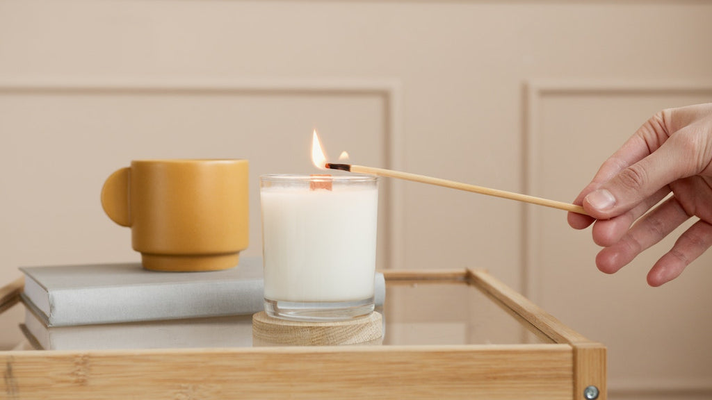 person lighting scented candle