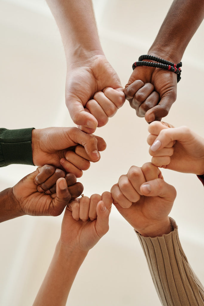 group of people fist bumping