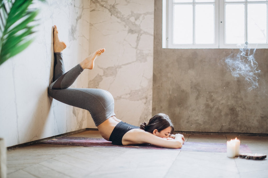 woman in yoga room with candles