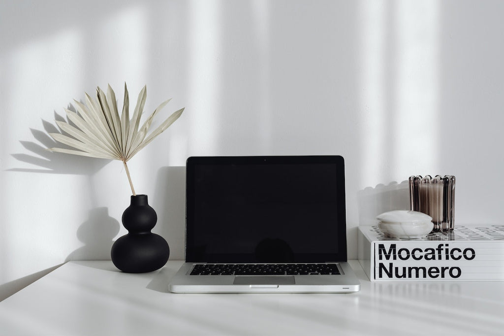 white desk with laptop and neutral accents