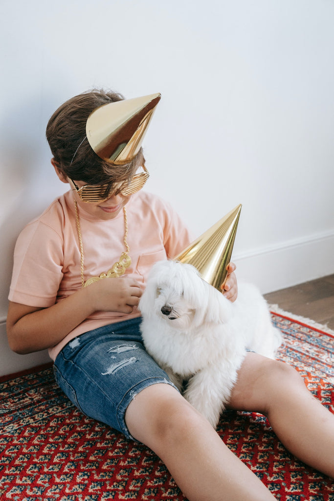 boy and dog wearing matching hats