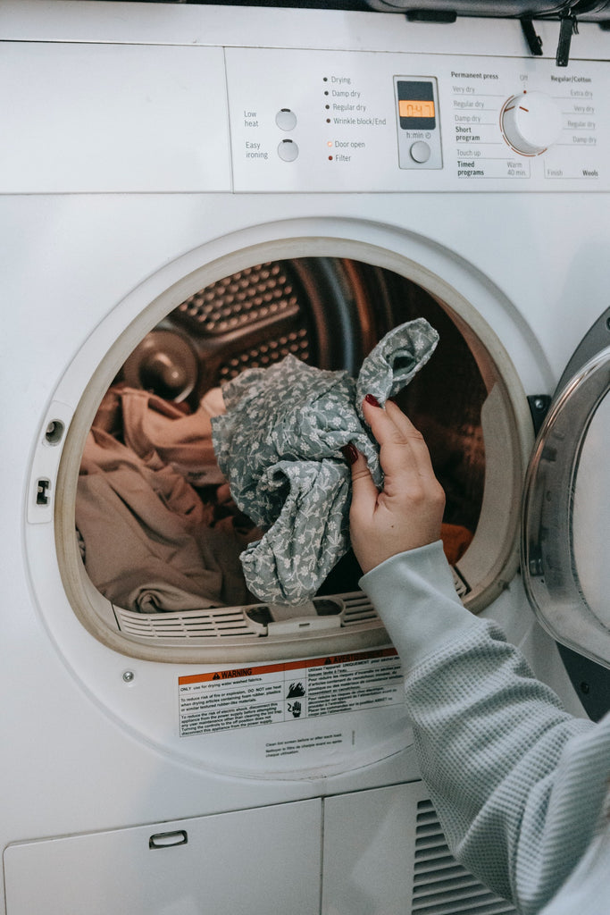 woman loading laundry into washing machine