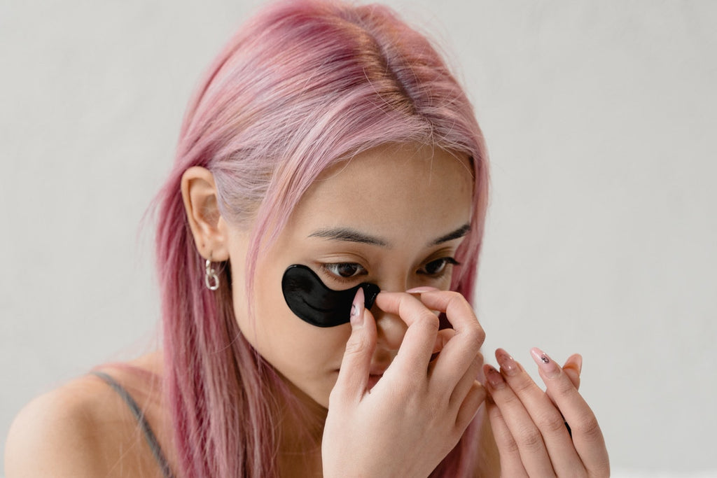 woman applying eye masks