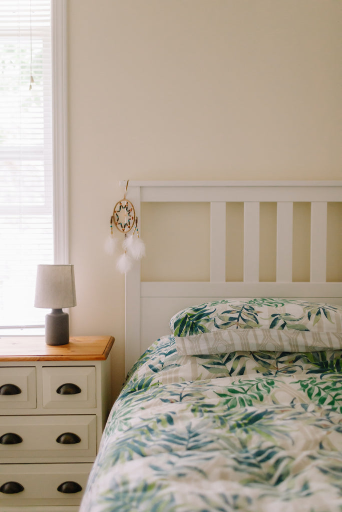 guest bedroom with natural light and green and cream accents