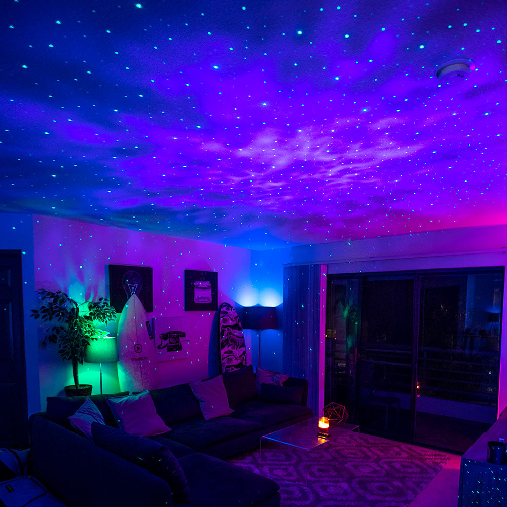 sky lite laser galaxy projector in living room with colored lights