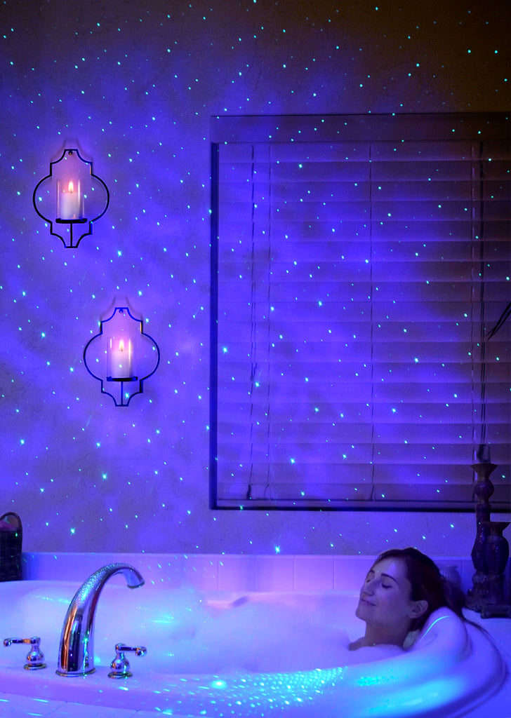 woman in bath tub under sky lite galaxy lights