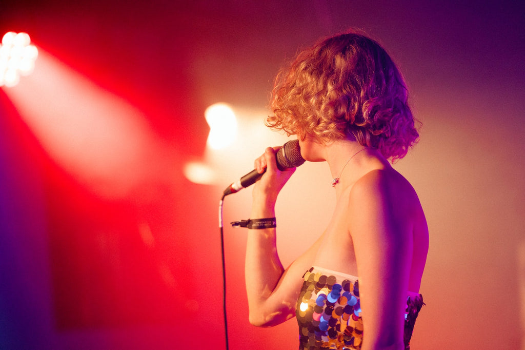 girl in sparkling dress singing karaoke