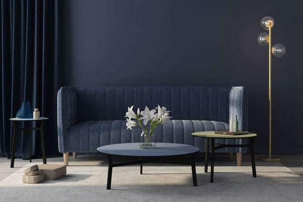 navy blue monchrome living room with vertical tufted sofa