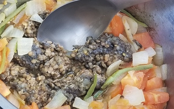 Add the steamed lentils right out of the package and sauté until heated through, then add water and bouillon cubes. Bring to boil.