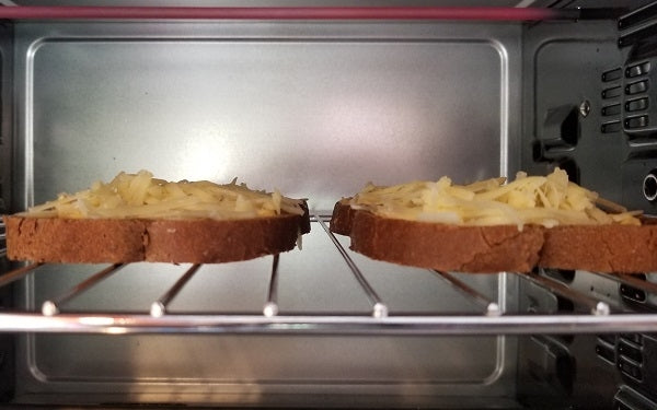 Meanwhile, preheat the broiler or a toaster oven. Spread mustard on bread and top with remaining cheese.