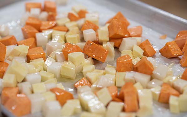 To roast the vegetables, preheat the oven to 400 degrees and cover 2 baking sheets with parchment paper. 