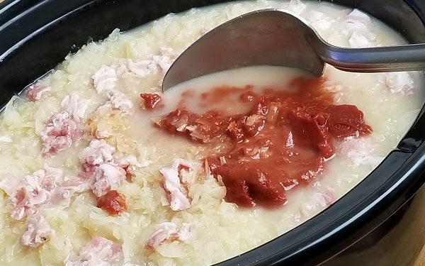 Cover the rolls with another layer of the remaining onions and sauerkraut. Sprinkle the diced pancetta over the top and then slowly pour in the bone broth until all layers are just submerged.
