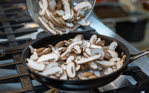 Slice mushrooms. Heat 2 tablespoons of the oil in a large sauté pan over medium high heat.