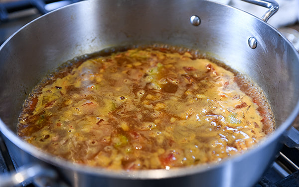 Add garlic, ginger and curry powder and sauté until fragrant; do not brown garlic.