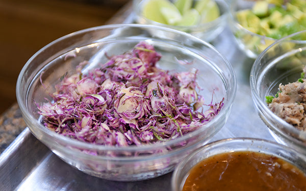 Toss the shredded Brussels sprouts with a splash of seasoned rice vinegar.