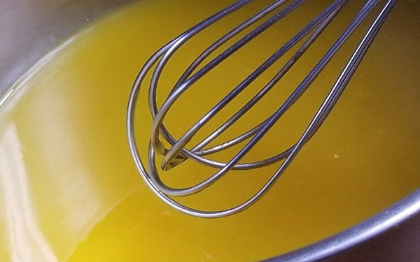 In a small sauce pan whisk together water, seeded passion fruit pulp, lemon juice and arrow root.