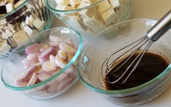 This recipe is best approached “mise en place”, meaning the eggplant, tofu, shallots and sauce should be prepared and measured before the cooking process is begun.