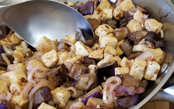 Stir in the eggplant and tofu pieces, continuing toss and cook until the sauce has thoroughly coated all. Serve over rice or enjoy as a standalone side dish!