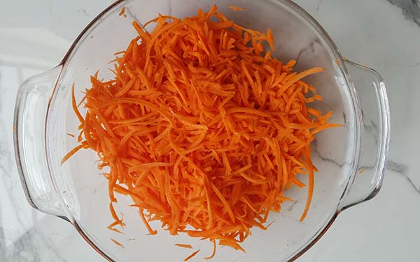 Shred carrots in a food processor using the large-hole disk. Transfer shredded carrots to a large bowl, you should have 5 cups.