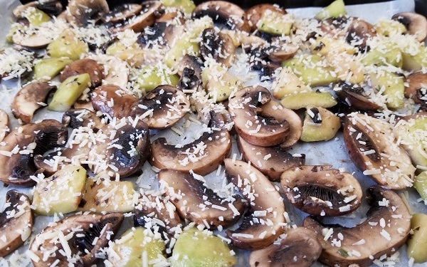 Arrange the mushrooms and feijoa pieces in a single layer on the baking sheet covered with parchment paper and sprinkle generously with Parmesan.