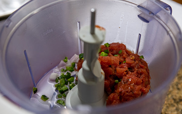 Add tomatoes, shallot, Seville orange juice and pepper; process into the food processor just until blended.