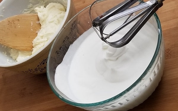 In a large bowl, beat mascarpone, cream cheese, 4 TBS of sweetener and remaining vanilla together until well combined. 