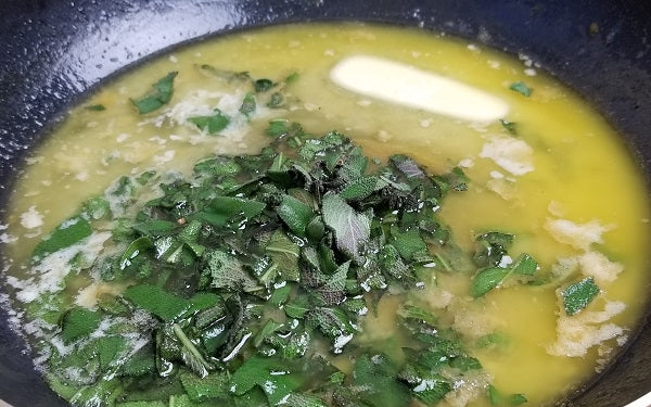 Add the stick of the butter to the pan, melt over low-medium heat. When the butter begins to get just slightly bubbly add the chopped garlic cloves. 