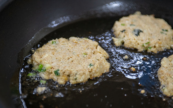 Heat a large skillet over medium heat, and then add 2 tablespoons of oil. When the oil sizzles add a patty one at a time making sure not to overcrowd the pan. 