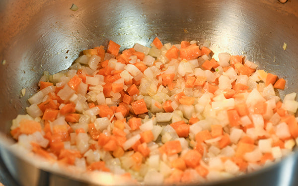 In a large sauté or stir-fry pan, cook the shallots, carrots and daikon over medium-high heat for about 3 minutes. 