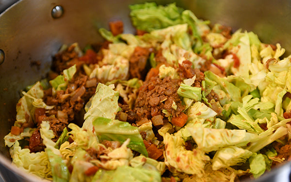 Add in the chopped cabbage and the diced tomatoes and stir while cooking for another 3-4 minutes until the cabbage is tender.