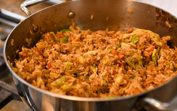 Add in the cooked rice and stir to combine. Pour over the sauce and stir again.