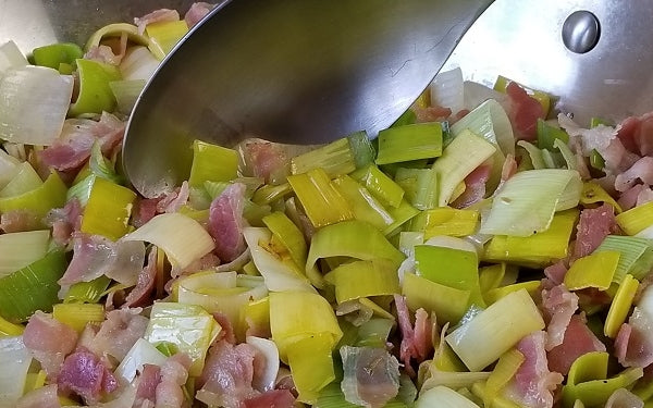 Heat olive oil in a large sauté pan over medium heat. Add the pancetta and sauté for 5 minutes, until it begins to brown.